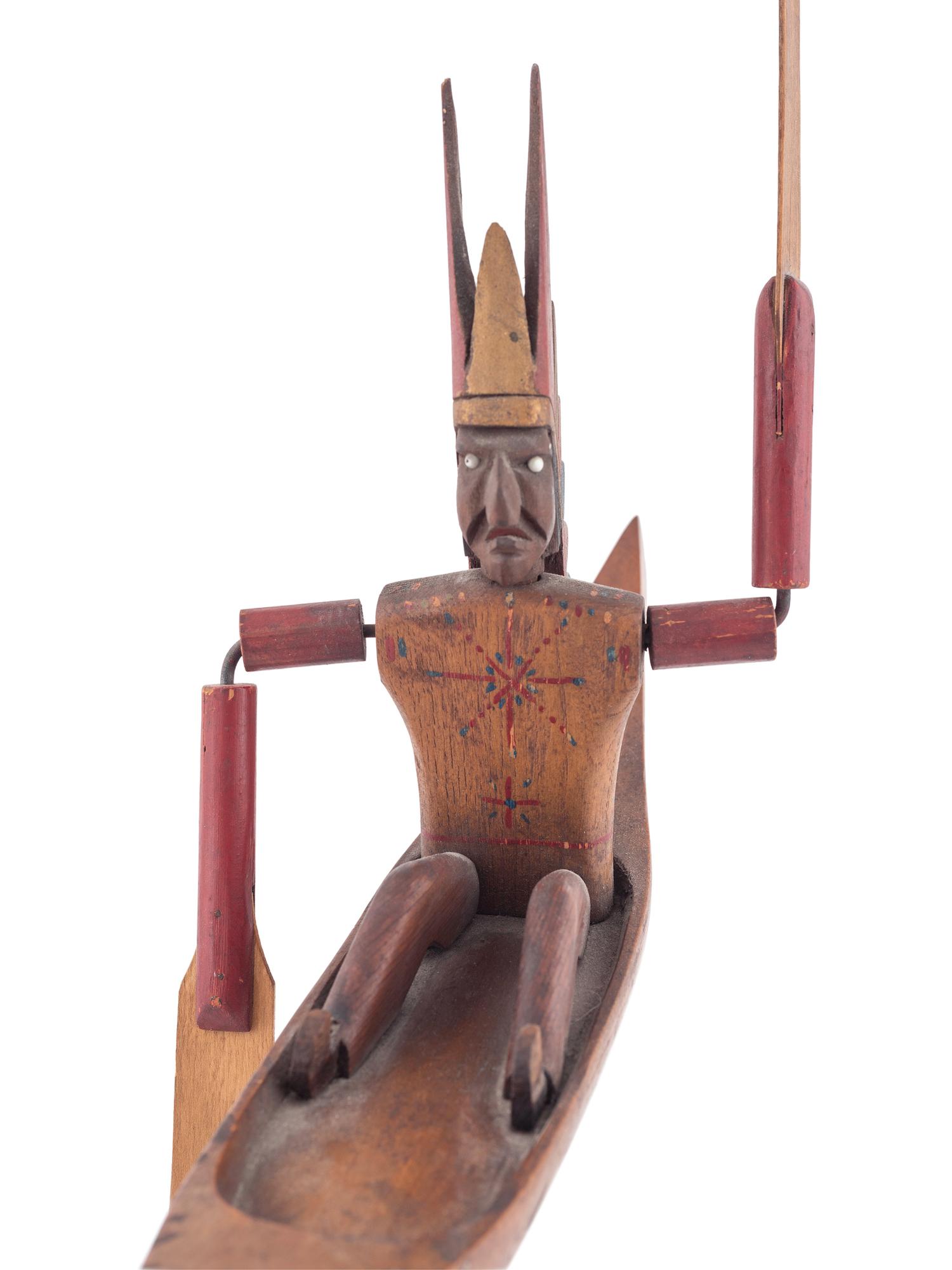 A Folk Art Whirligig of an American Indian in a Canoe