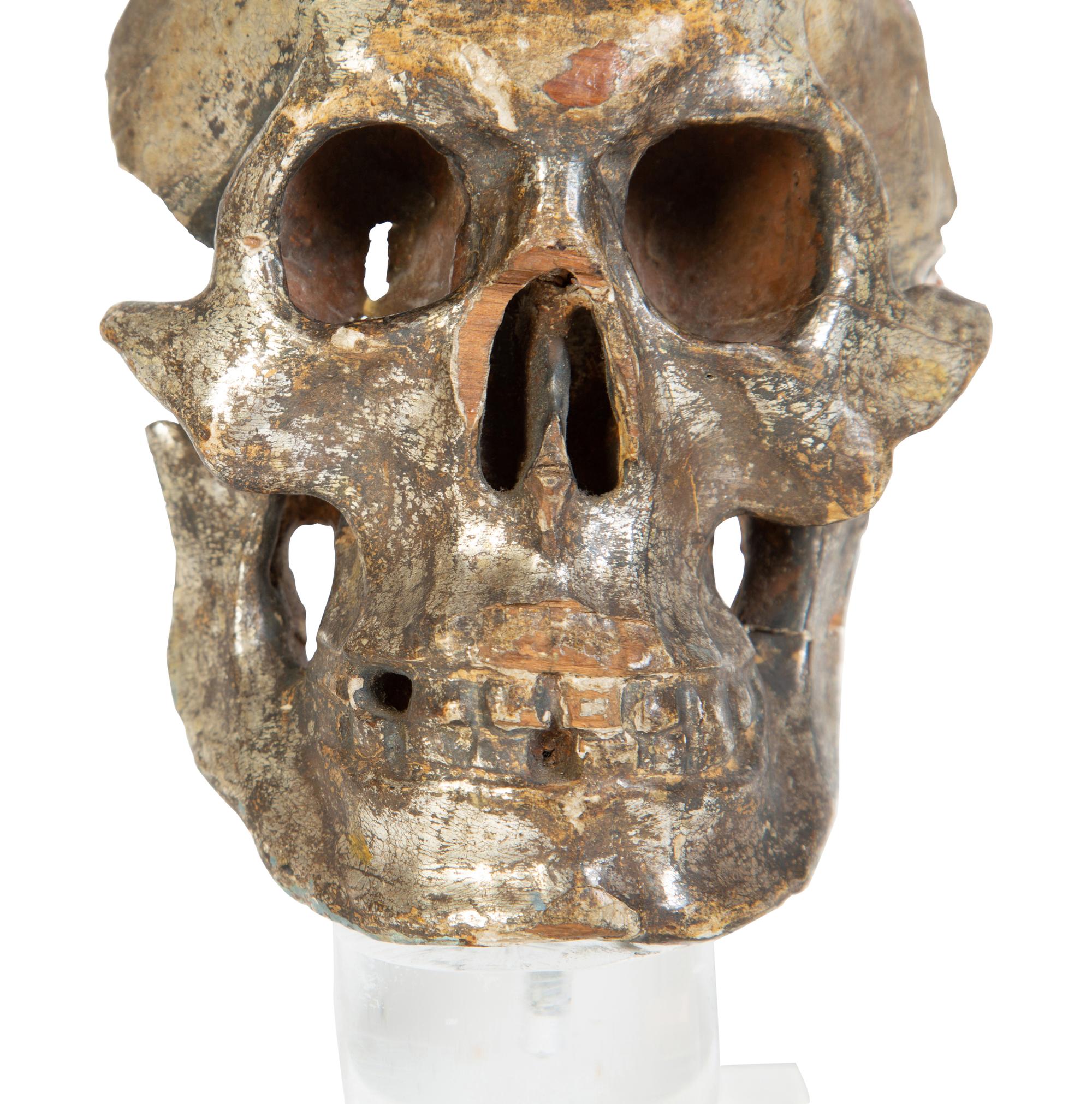 Two Italian Silvered Wood Memento Mori Skulls — 17TH CENTURY