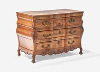 A Louis XV Provincial Carved Fruitwood Serpentine and Paneled-Top Bombé Commode