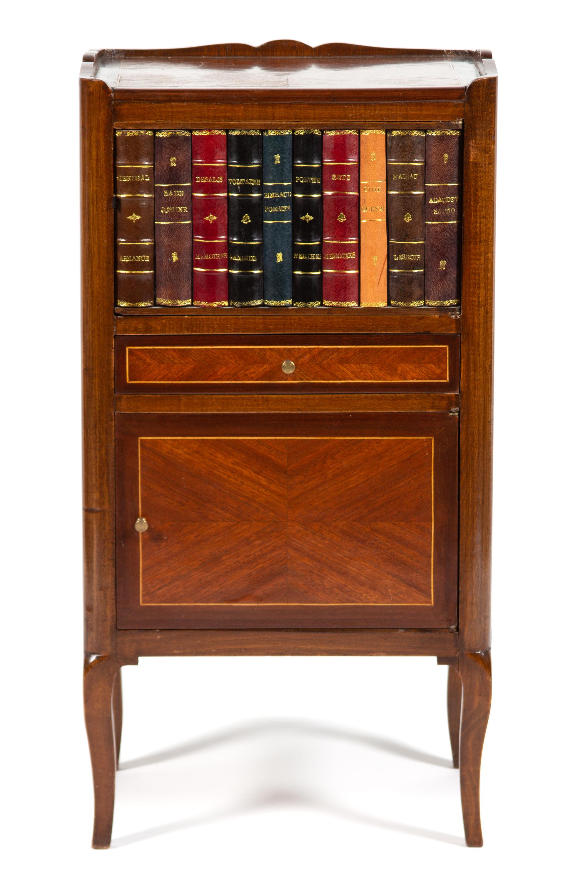 A Louis XV/XVI Style Walnut and Faux Book Side Cabinet Height 29 3/4 x width 15 1/2 x depth 11 3/4 inches. — CIRCA 1900