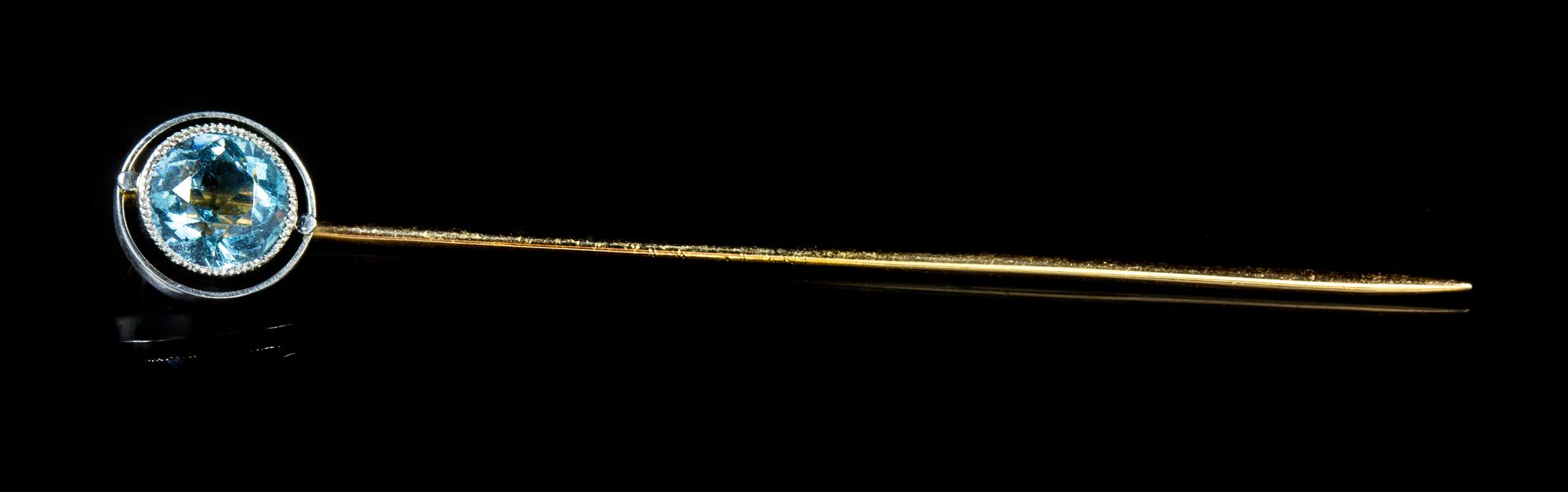 A Platinum, Yellow Gold and Aquamarine Stick Pin, 1.10 dwts.
