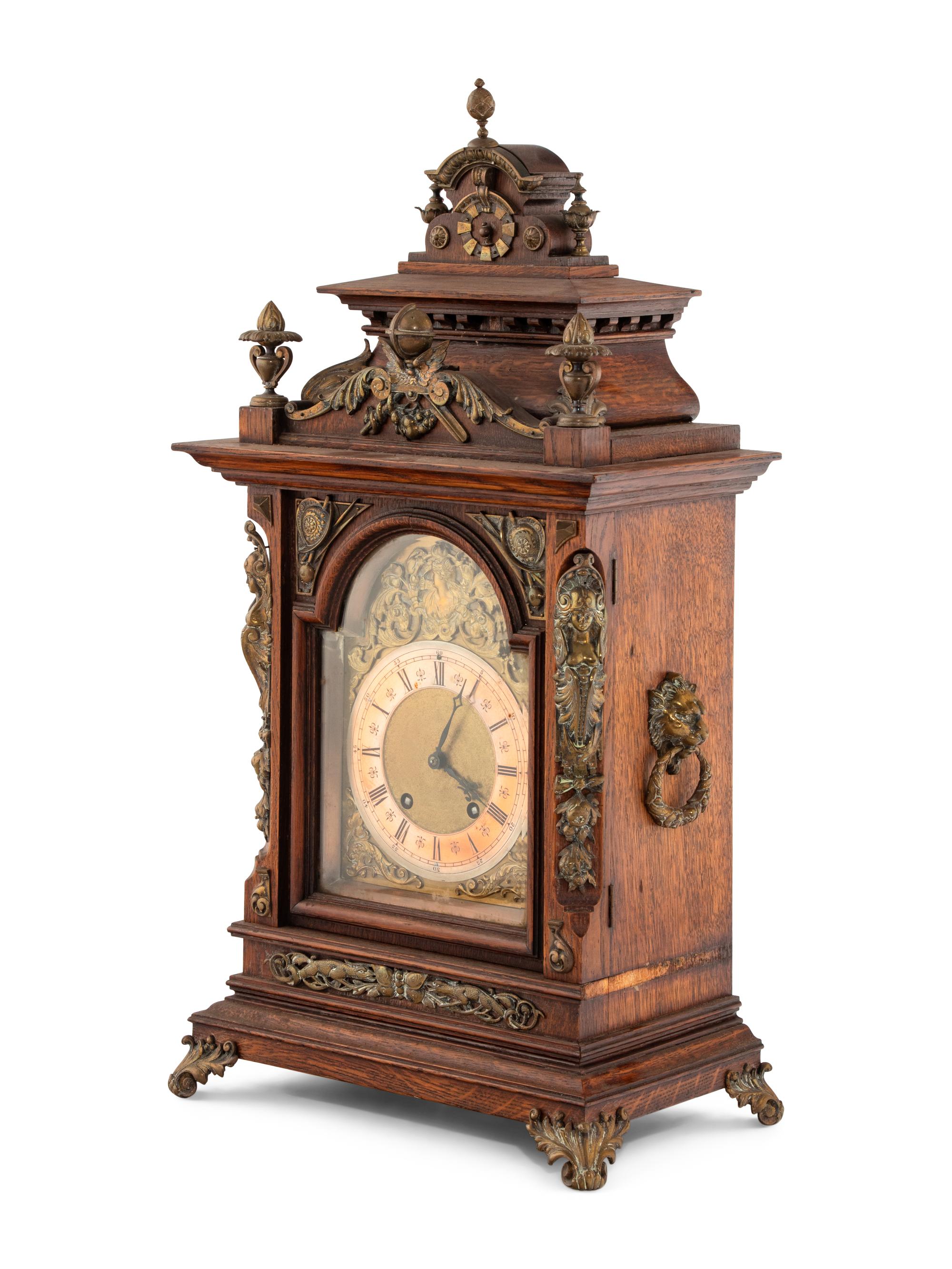 A Lenzkirch Renaissance Revival Gilt Metal Mounted Oak Mantel Clock