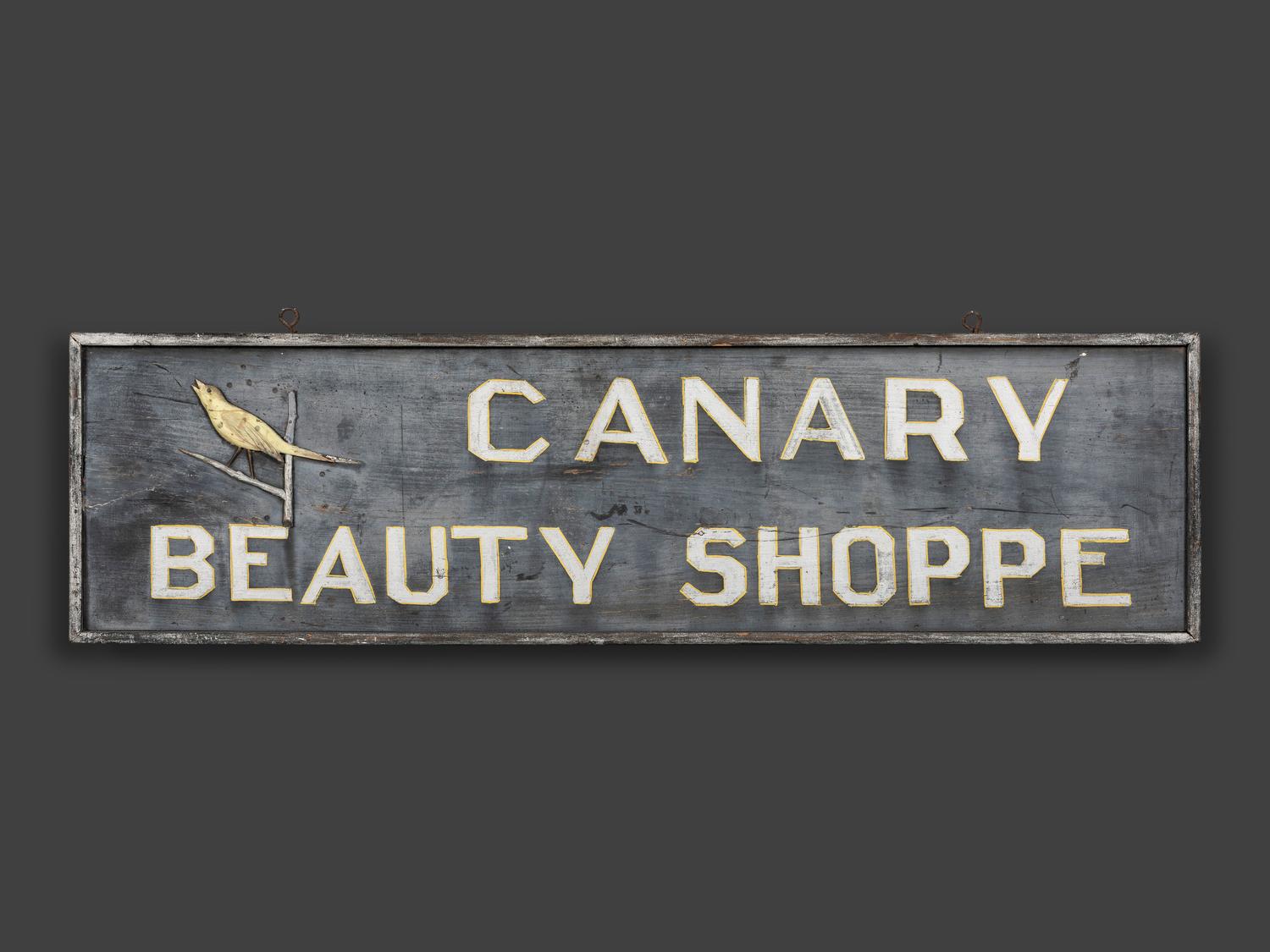 A Canary Beauty Shoppe Painted Wood Double-Sided Sign