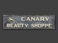 A Canary Beauty Shoppe Painted Wood Double-Sided Sign