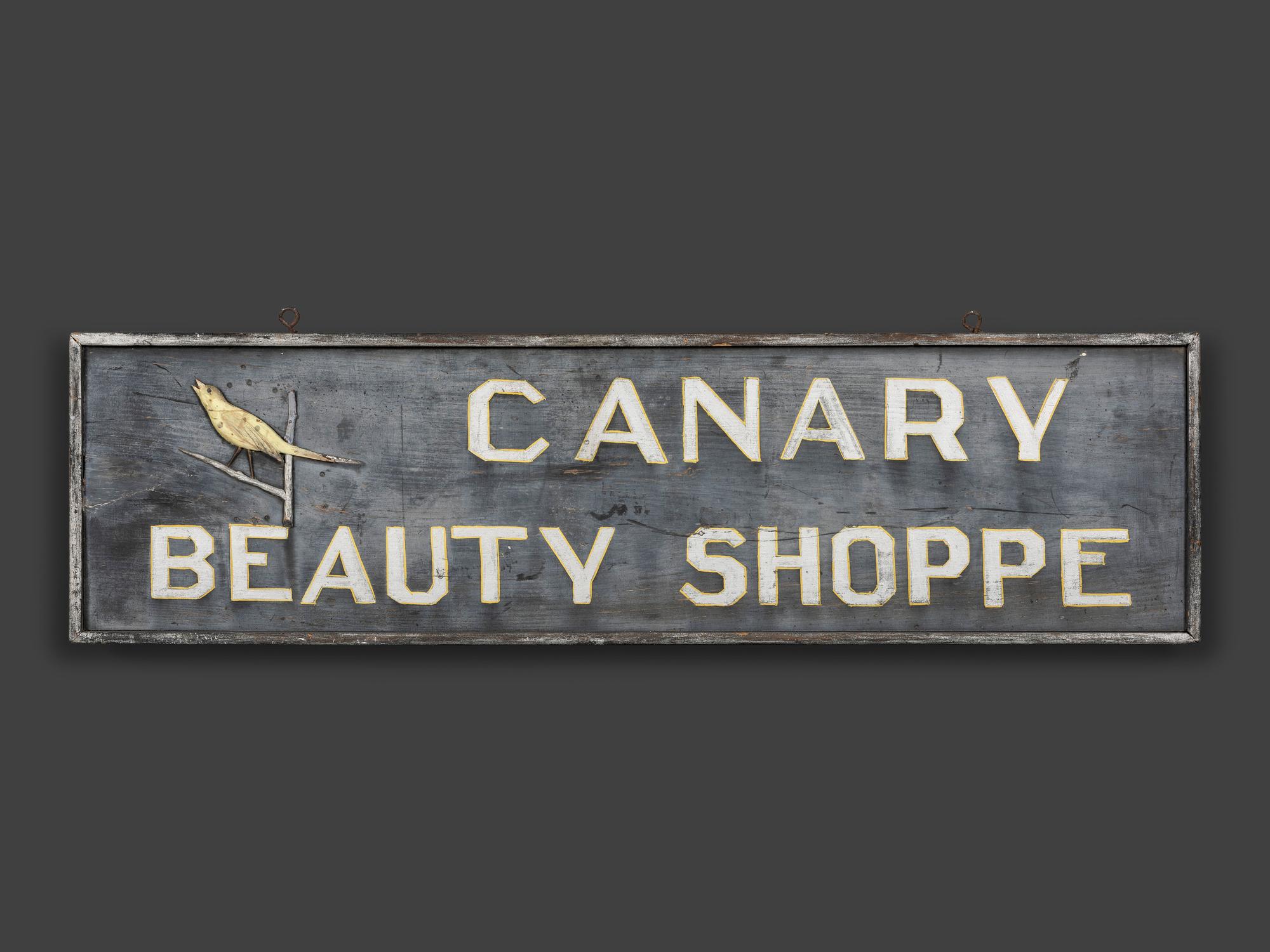 A Canary Beauty Shoppe Painted Wood Double-Sided Sign