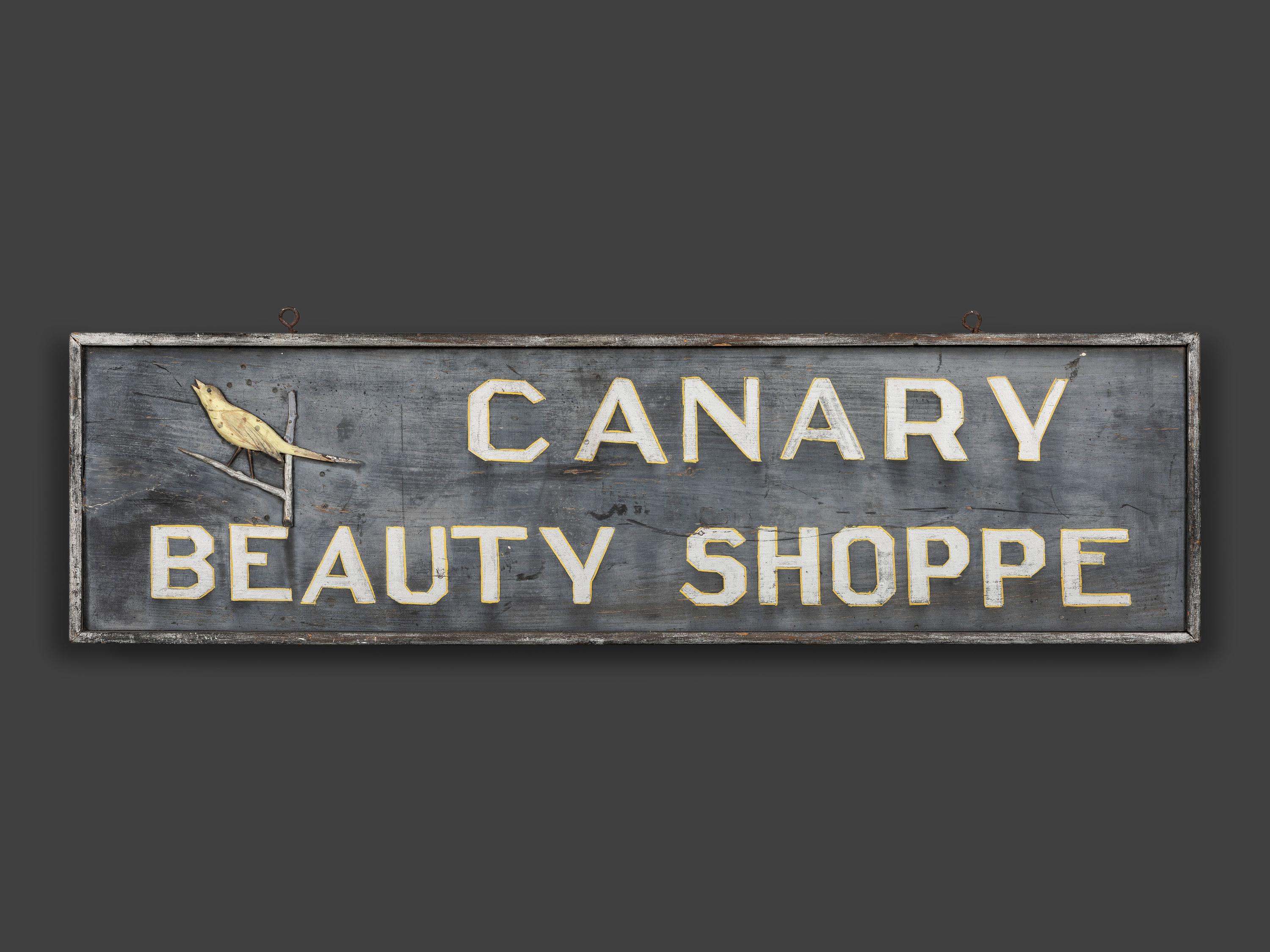A Canary Beauty Shoppe Painted Wood Double-Sided Sign