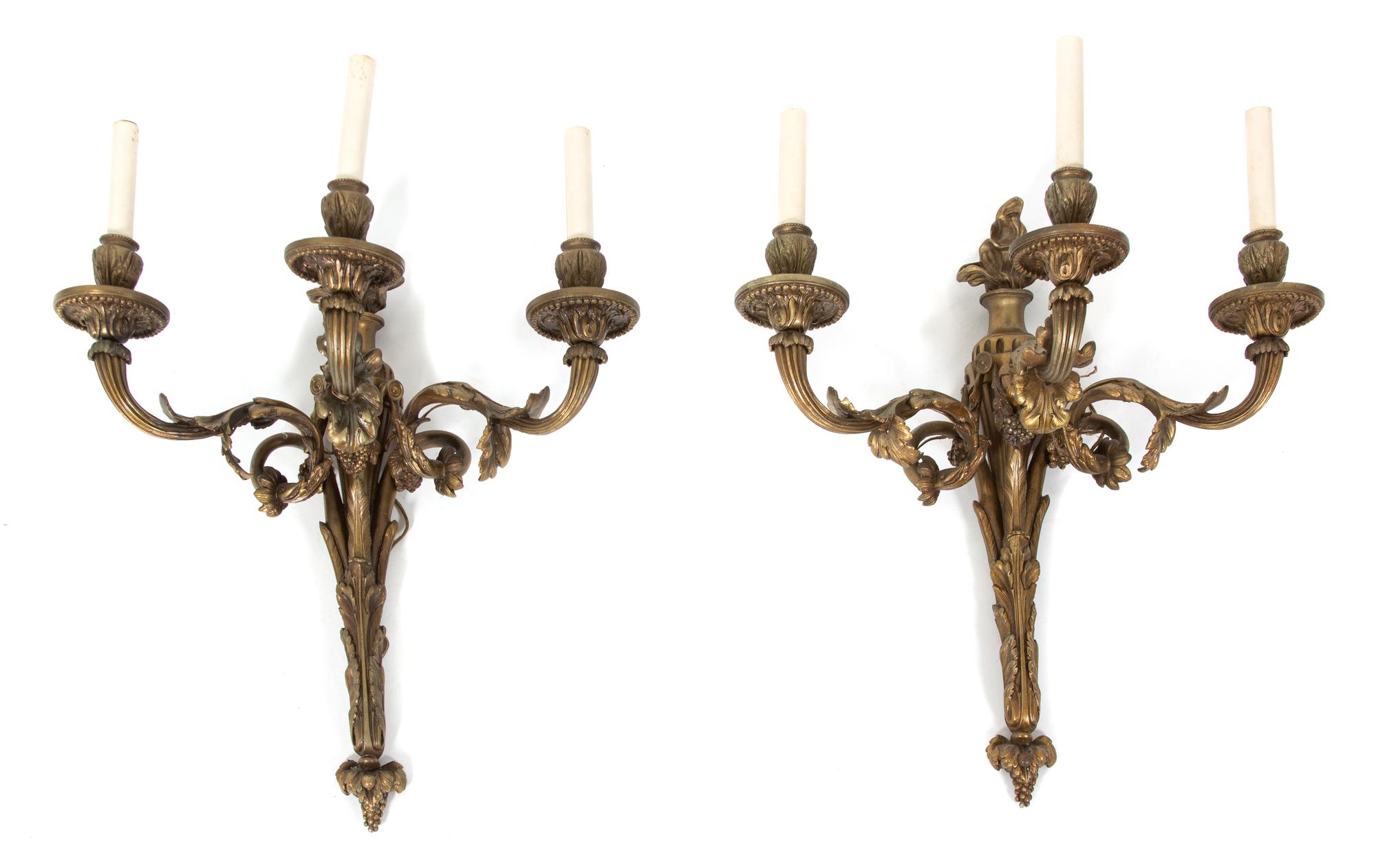 A Pair of Louis XVI Style Gilt Bronze Three-Light Wall Sconces Height 20 x length 19 inches. — 19TH CENTURY