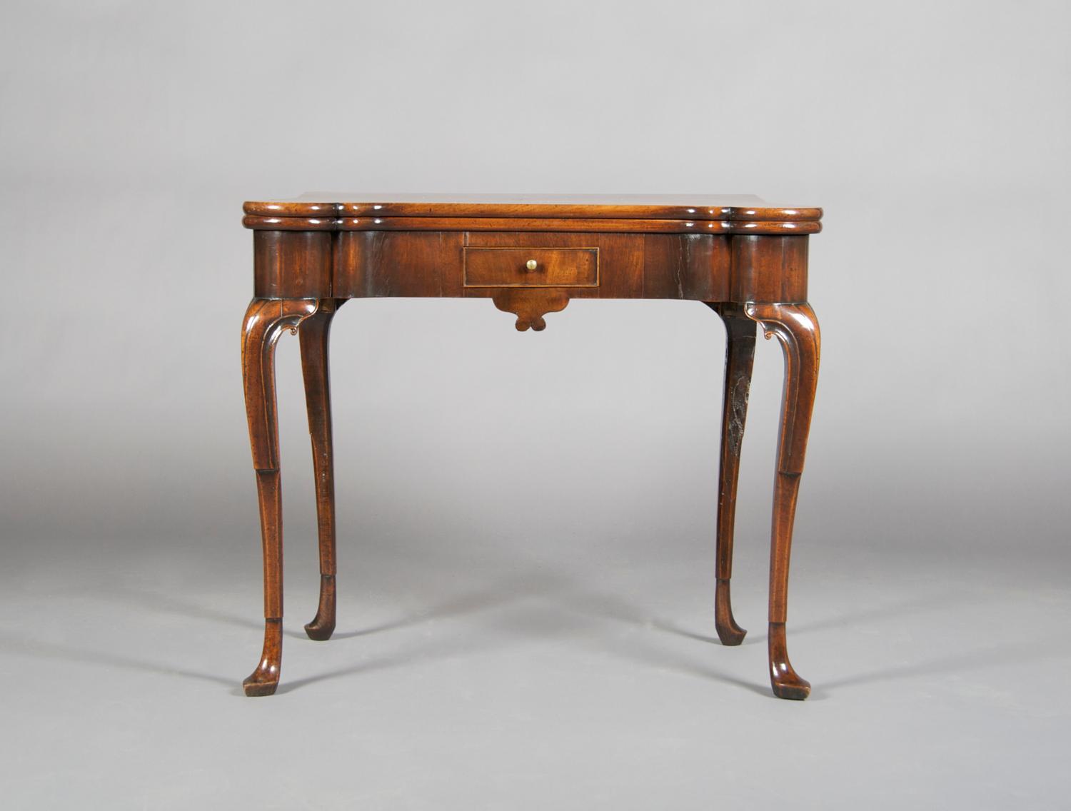 A Mahogany Games Table, Height 28 1/2 x width 33 1/2 x depth (closed) 16 1/2 inches.