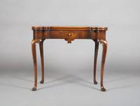 A Mahogany Games Table, Height 28 1/2 x width 33 1/2 x depth (closed) 16 1/2 inches.