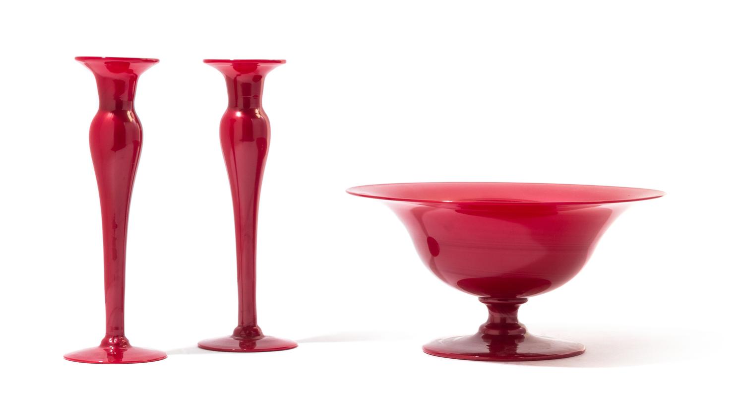 Attributed to Steuben, an American three piece garniture comprising a pair of candle sticks and a footed bowl