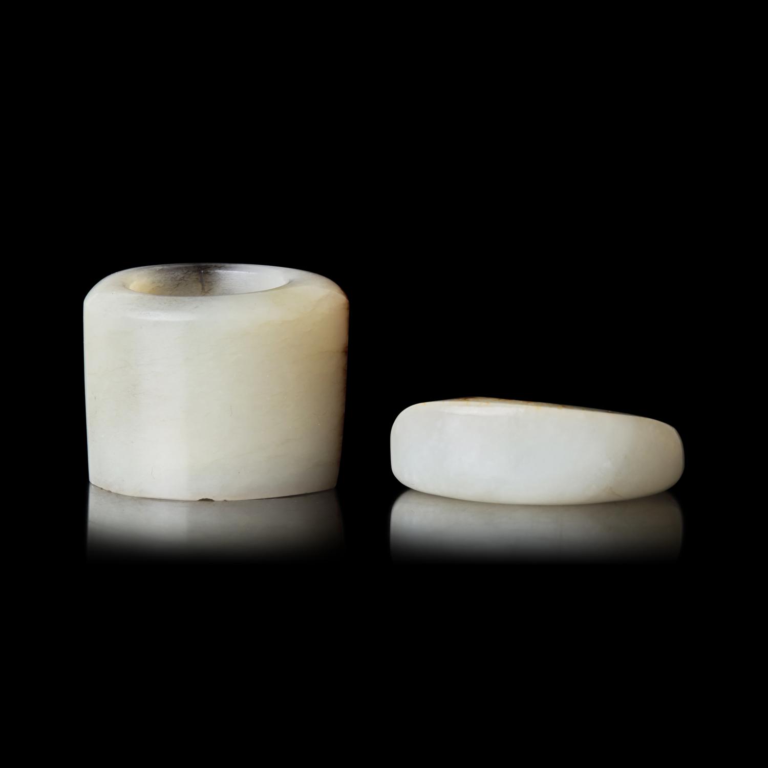 Two Chinese Russet and White Jade Archer's Rings, Qing Dynasty 清 白玉留皮扳指兩枚
