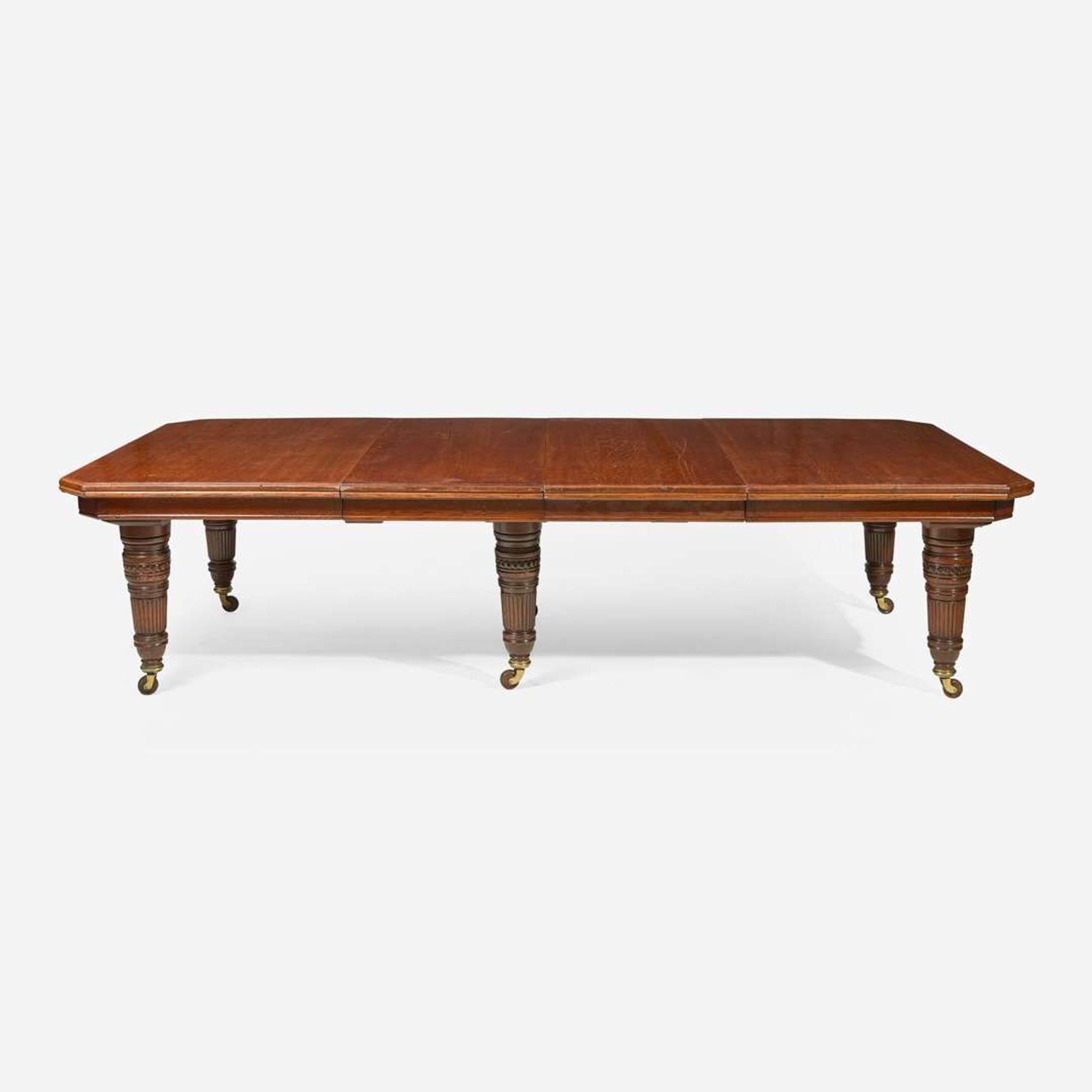 An English Aesthetic Movement carved oak dining table and set of twelve dining chairs Lamb of Manchester, Manchester, England, circa 1875