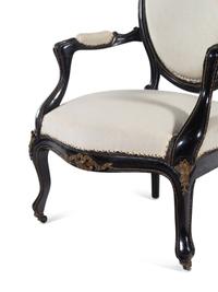 A Pair of Napoleon III Gilt Metal Mounted Ebonized Fauteuils