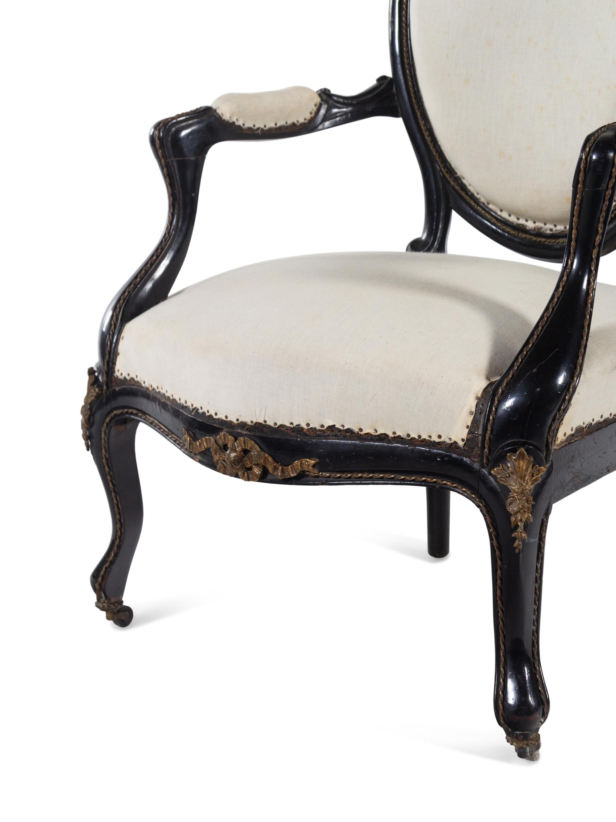 A Pair of Napoleon III Gilt Metal Mounted Ebonized Fauteuils