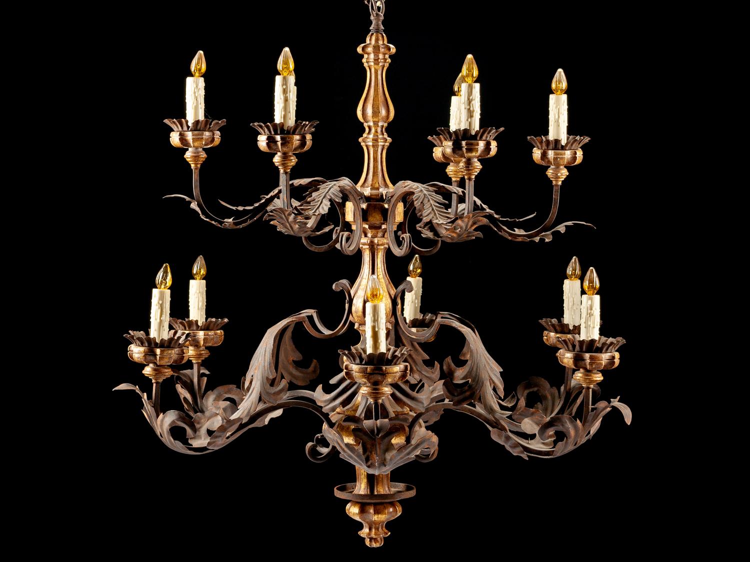 A Spanish Renaissance Style Carved Giltwood, Wrought Iron and Tôle Twelve-Light Chandelier