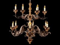 A Spanish Renaissance Style Carved Giltwood, Wrought Iron and Tôle Twelve-Light Chandelier