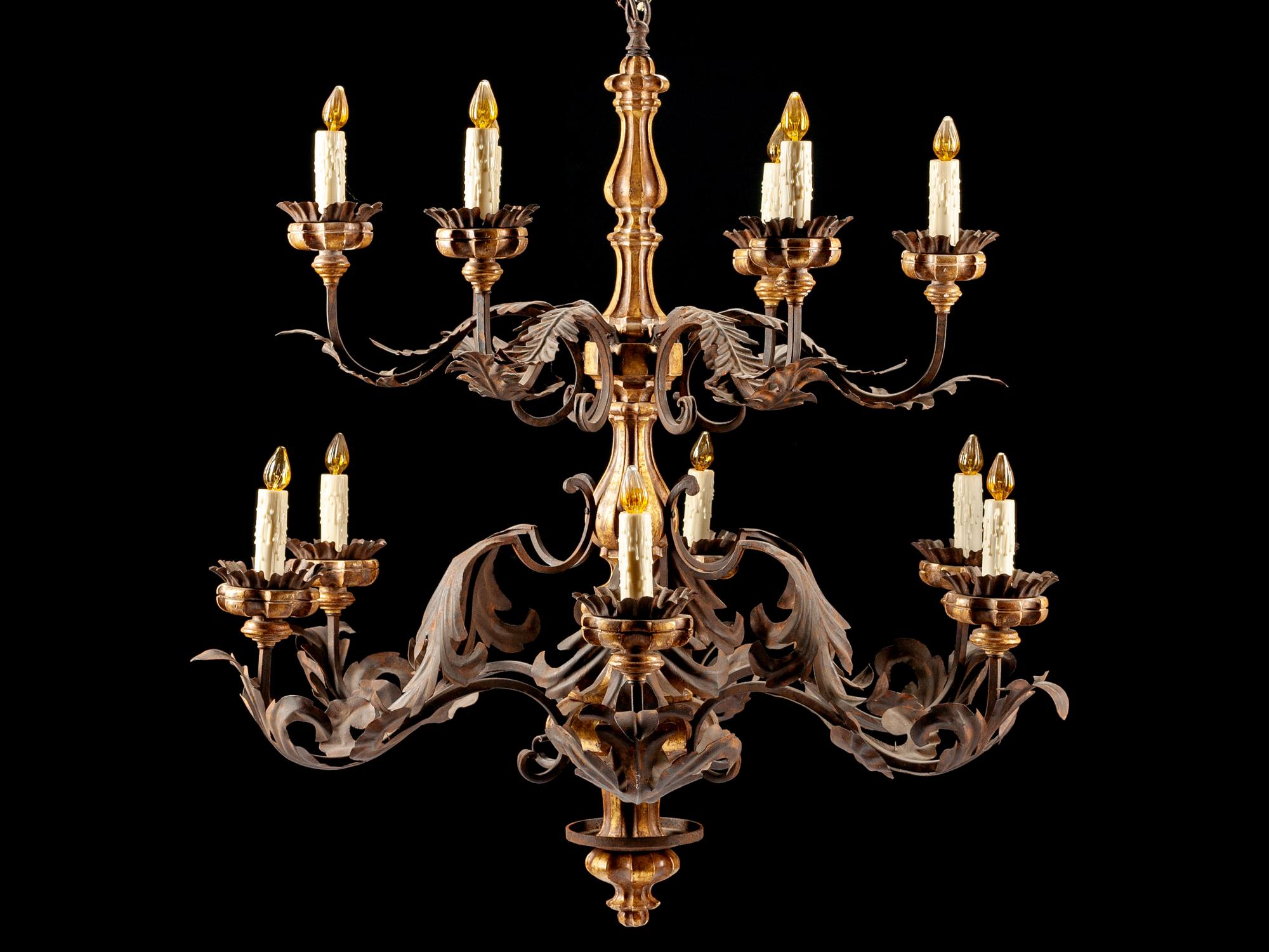 A Spanish Renaissance Style Carved Giltwood, Wrought Iron and Tôle Twelve-Light Chandelier