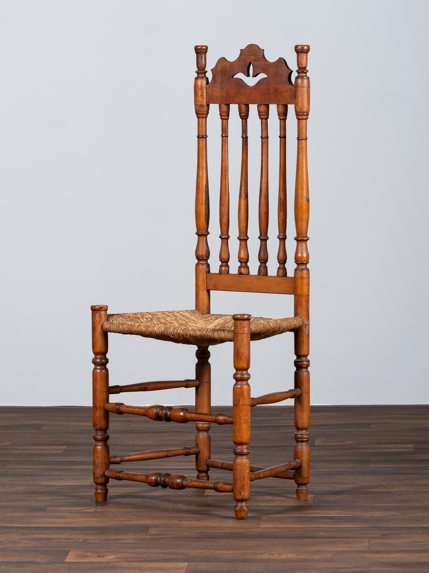 A William and Mary Style Turned and Pierced Carved Banister-Back Rush Seat Side Chair