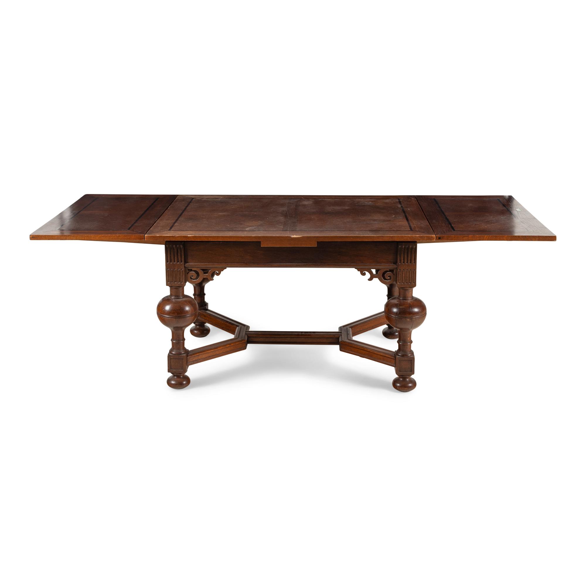 A Baroque Style Oak Draw-Leaf Dining Table