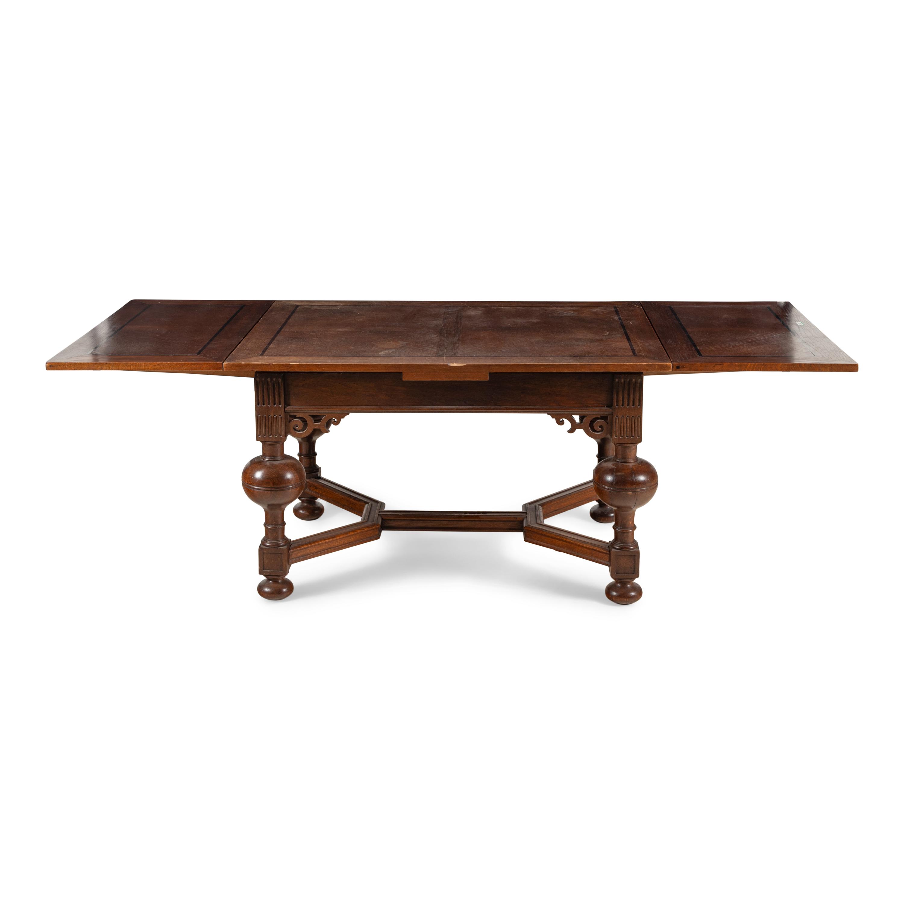 A Baroque Style Oak Draw-Leaf Dining Table