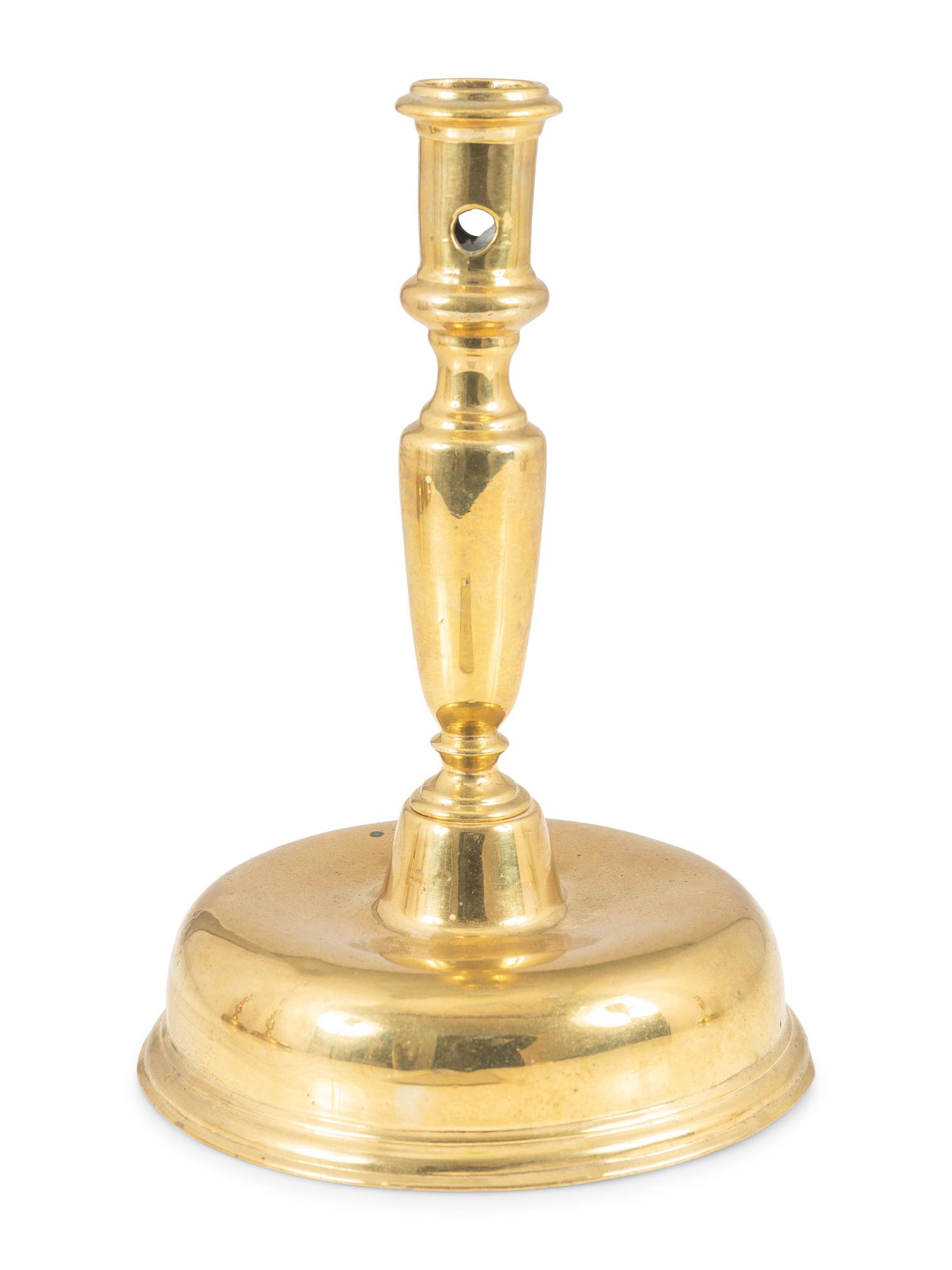 A Continental Brass Bell-Bottom Candlestick