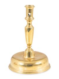 A Continental Brass Bell-Bottom Candlestick