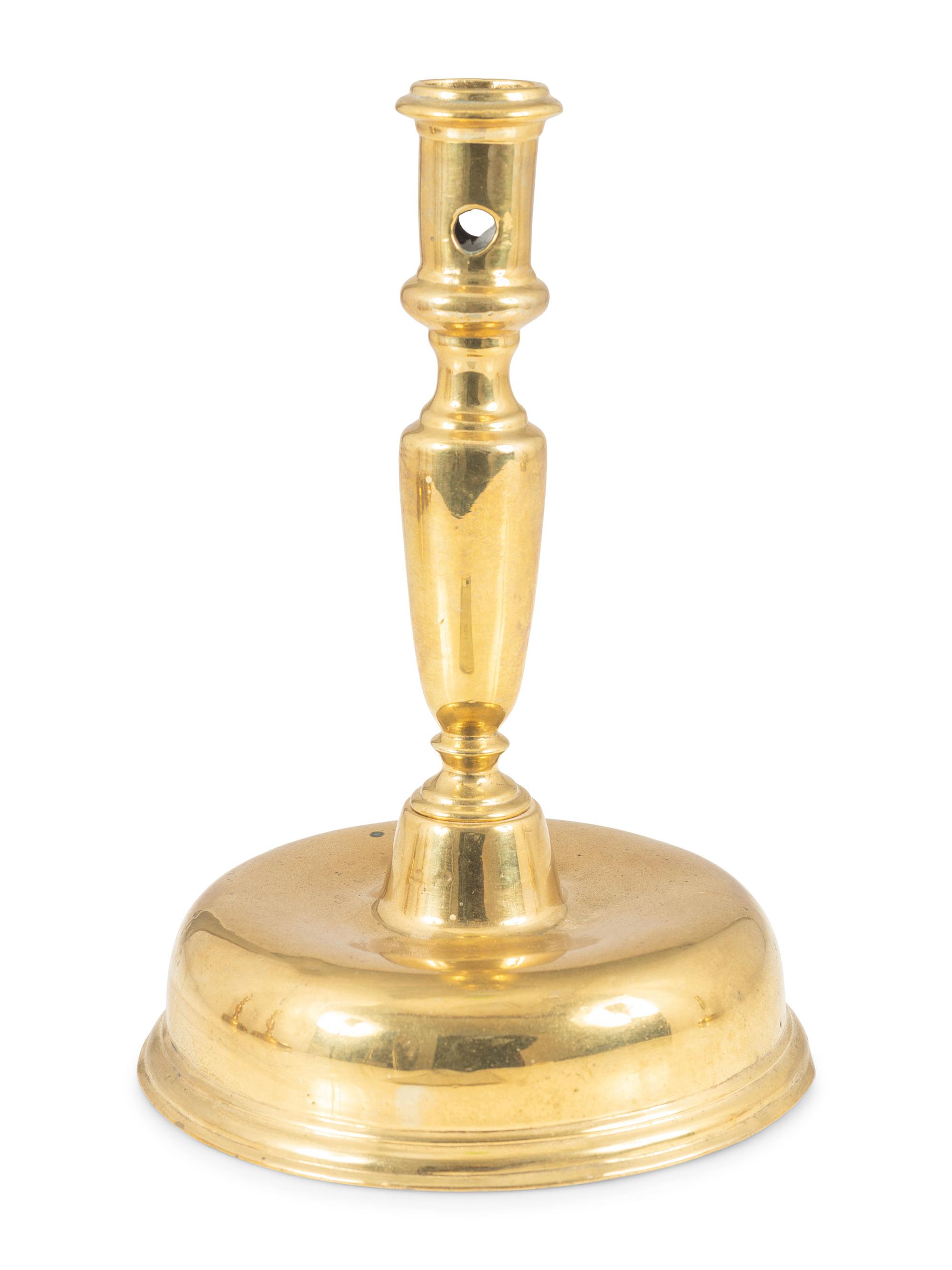 A Continental Brass Bell-Bottom Candlestick