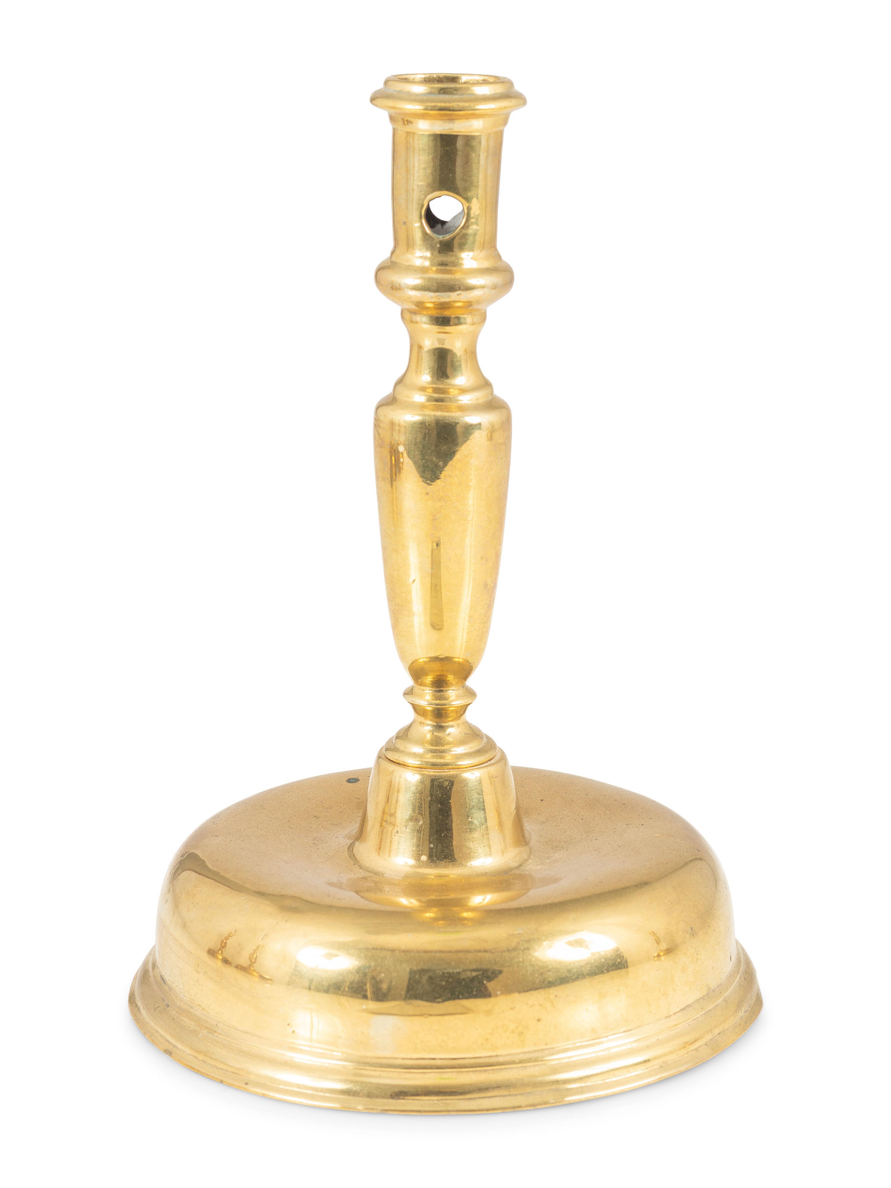 A Continental Brass Bell-Bottom Candlestick