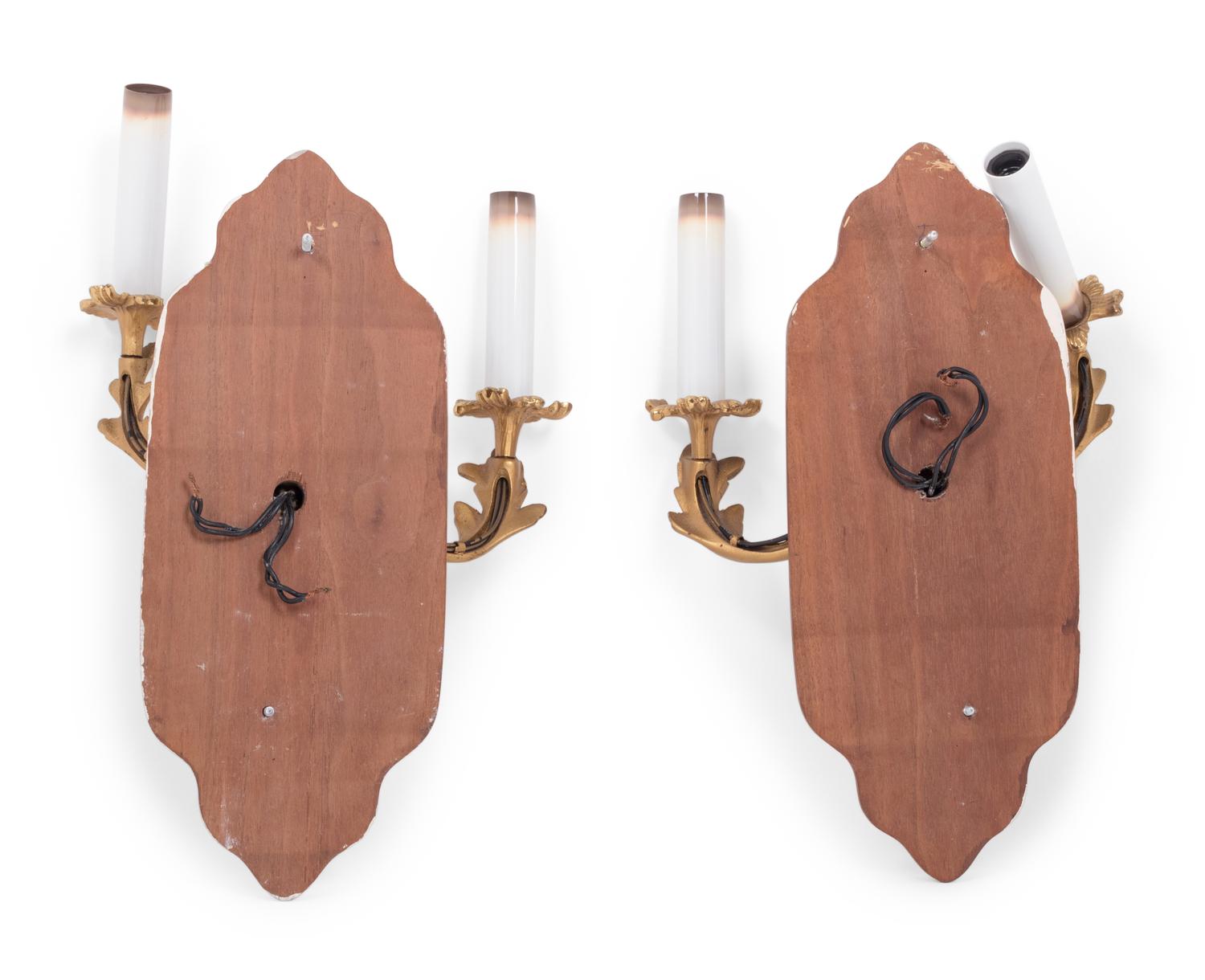 A Pair of Louis XV Style Gilt Metal Two-Light Sconces on Walnut Plaques