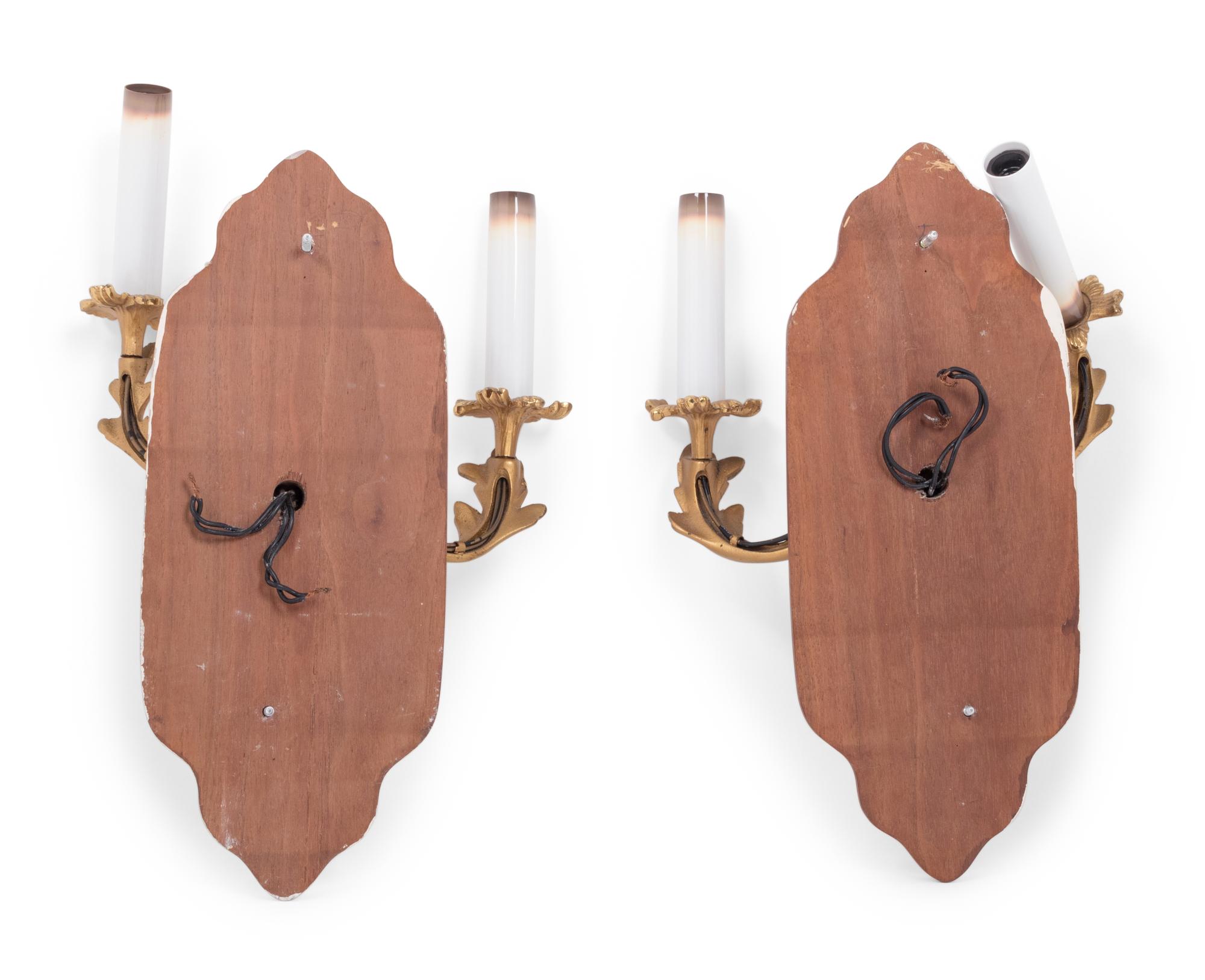 A Pair of Louis XV Style Gilt Metal Two-Light Sconces on Walnut Plaques