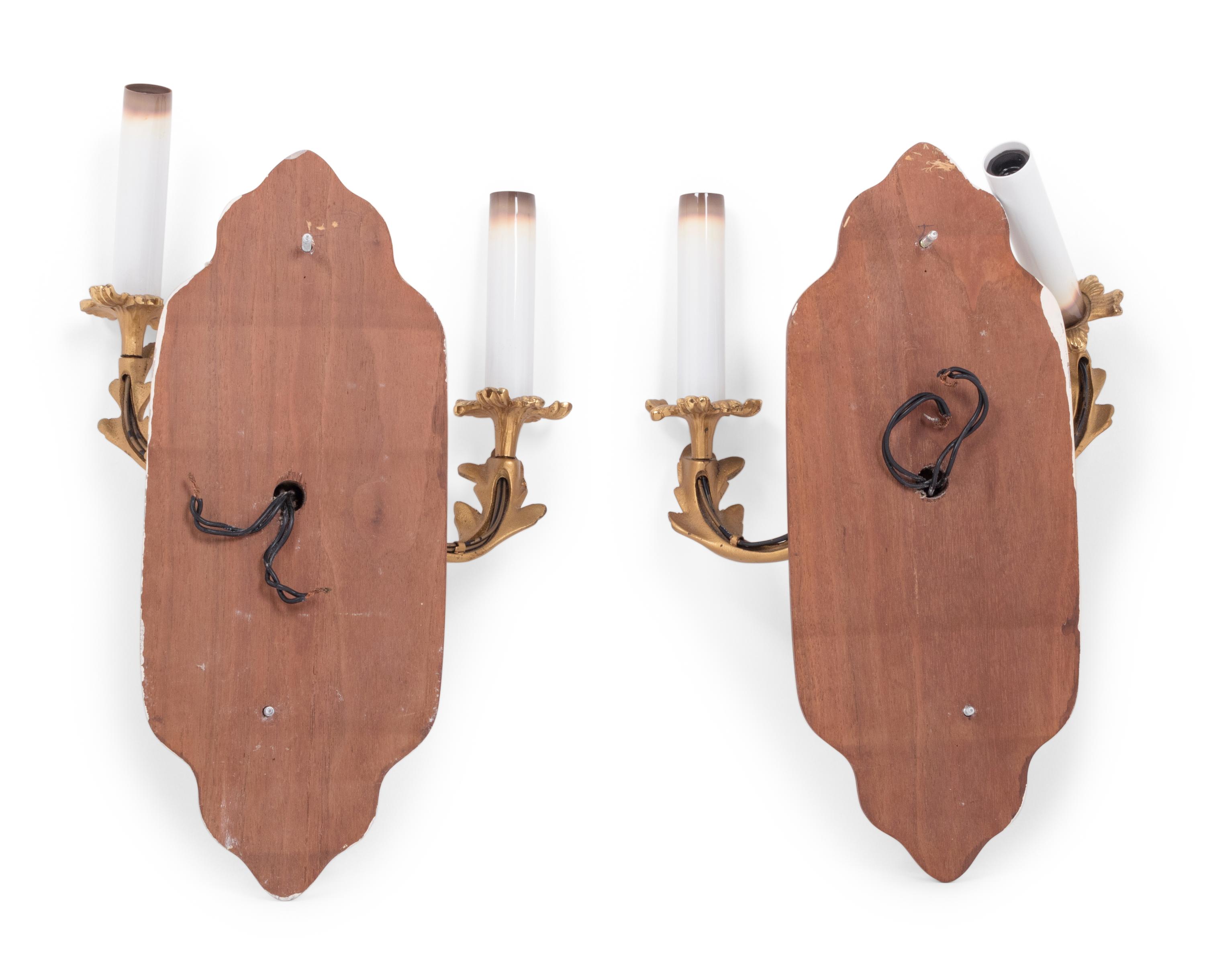 A Pair of Louis XV Style Gilt Metal Two-Light Sconces on Walnut Plaques