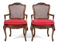 A Pair of Louis XV Provincial Style Carved Walnut Fauteuils Height 39 inches. — 19TH CENTURY