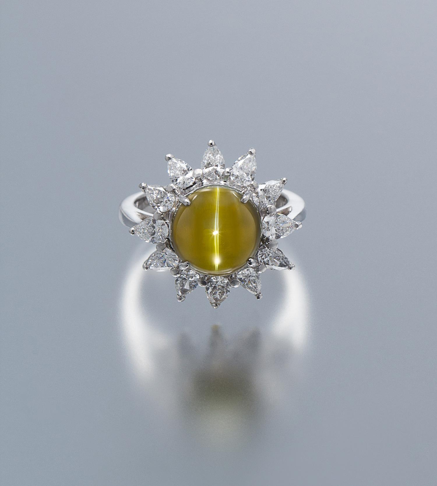 A Platinum, 18 Karat White Gold, Cat's Eye Chryosberyl and Diamond Ring, 5.90 dwts.