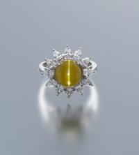 A Platinum, 18 Karat White Gold, Cat's Eye Chryosberyl and Diamond Ring, 5.90 dwts.