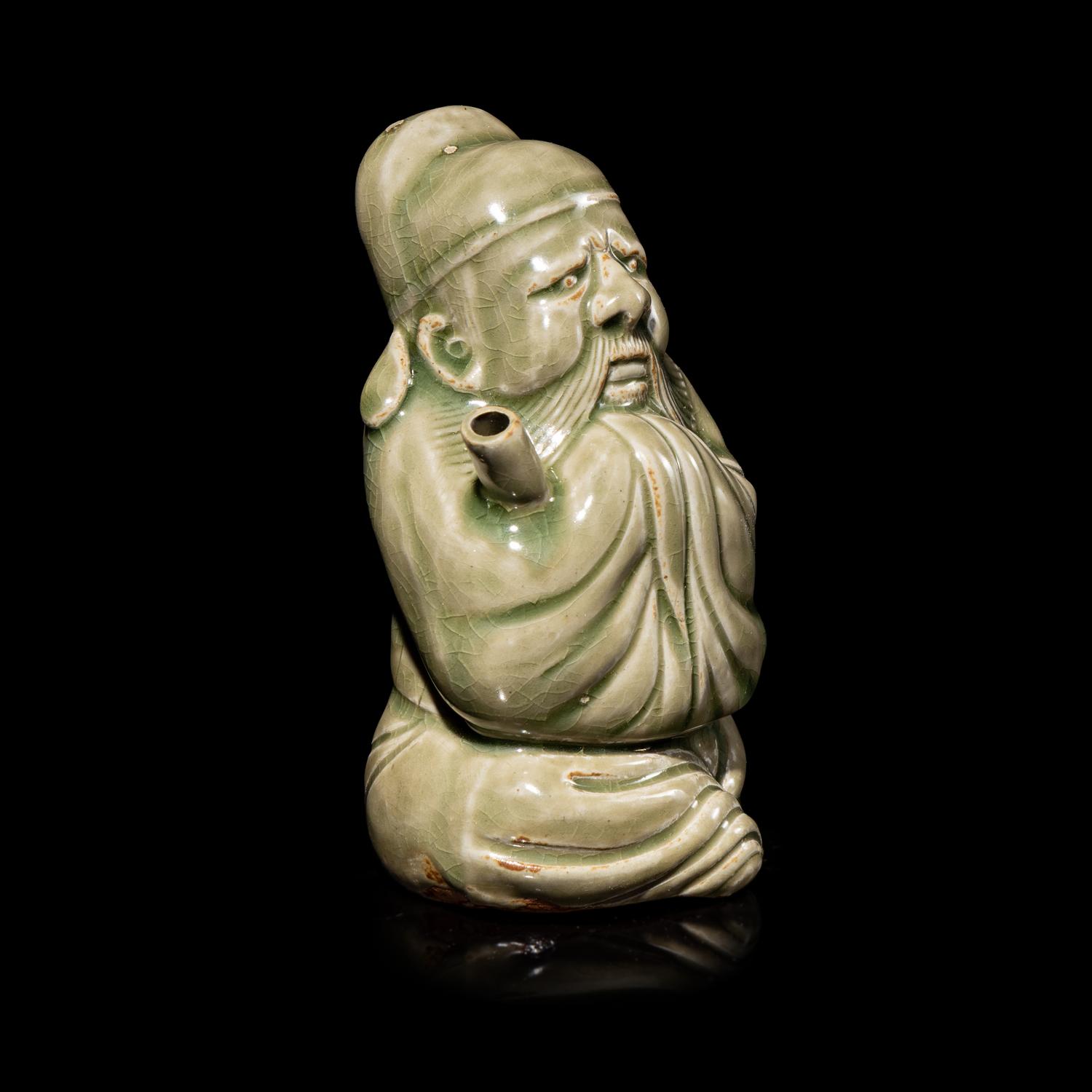 A Chinese Celadon Glazed Porcelain Figure Water Dropper, Yandi — 青釉人物形硯滴