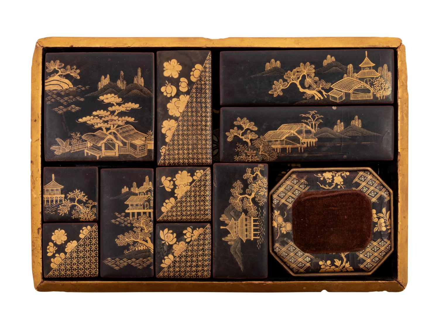 A Set of Eleven Small Japanese Gilt and Black Lacquer Stationary Boxes