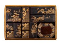 A Set of Eleven Small Japanese Gilt and Black Lacquer Stationary Boxes