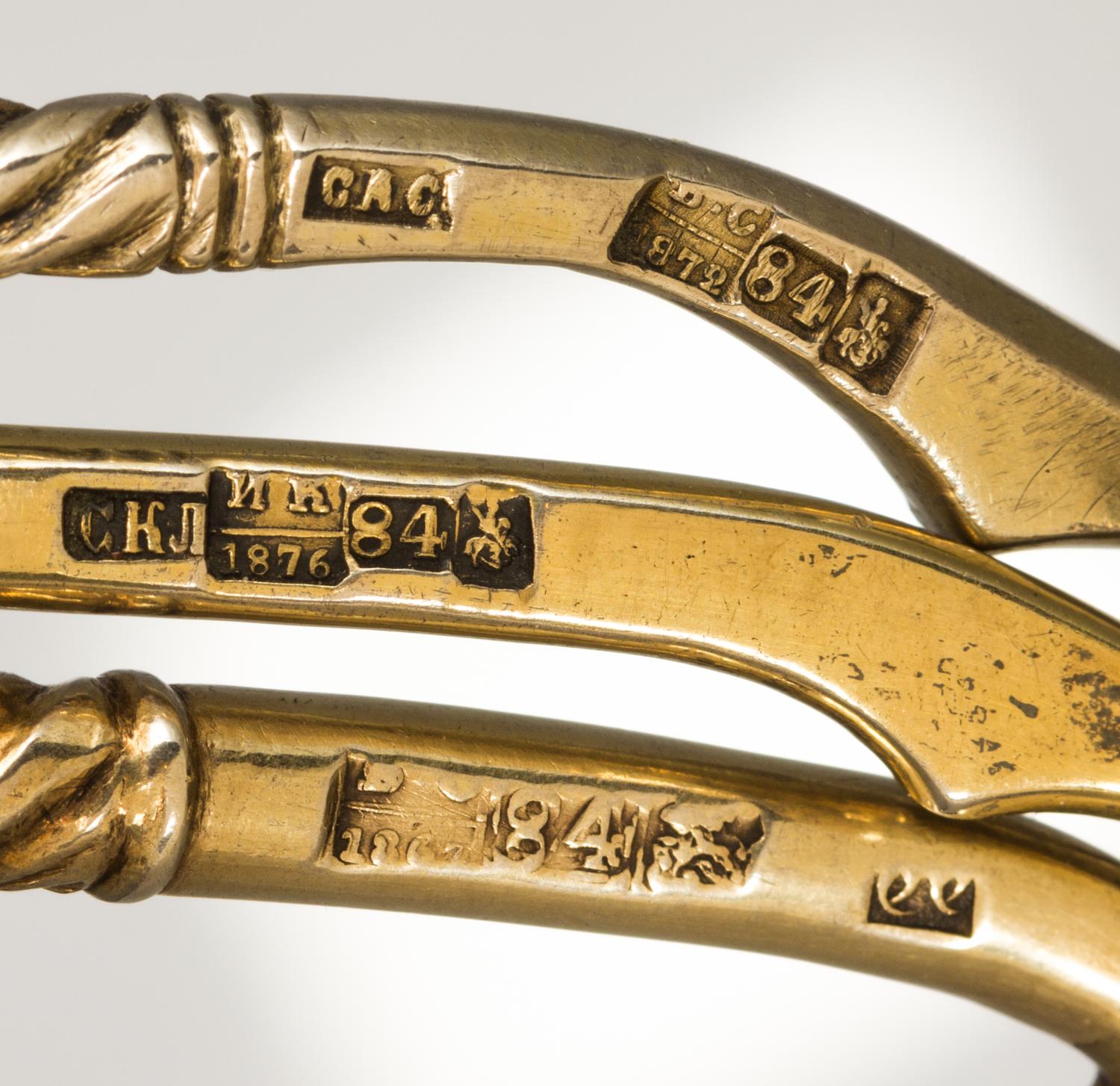 Three Russian Silver-Gilt Serving Spoons, Marks of S. Stroganov, Stepan Levin and GAC, Moscow, 19th century, each having a twist handle