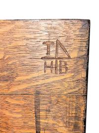 An Arts and Crafts Carved Oak Wine Cellarette