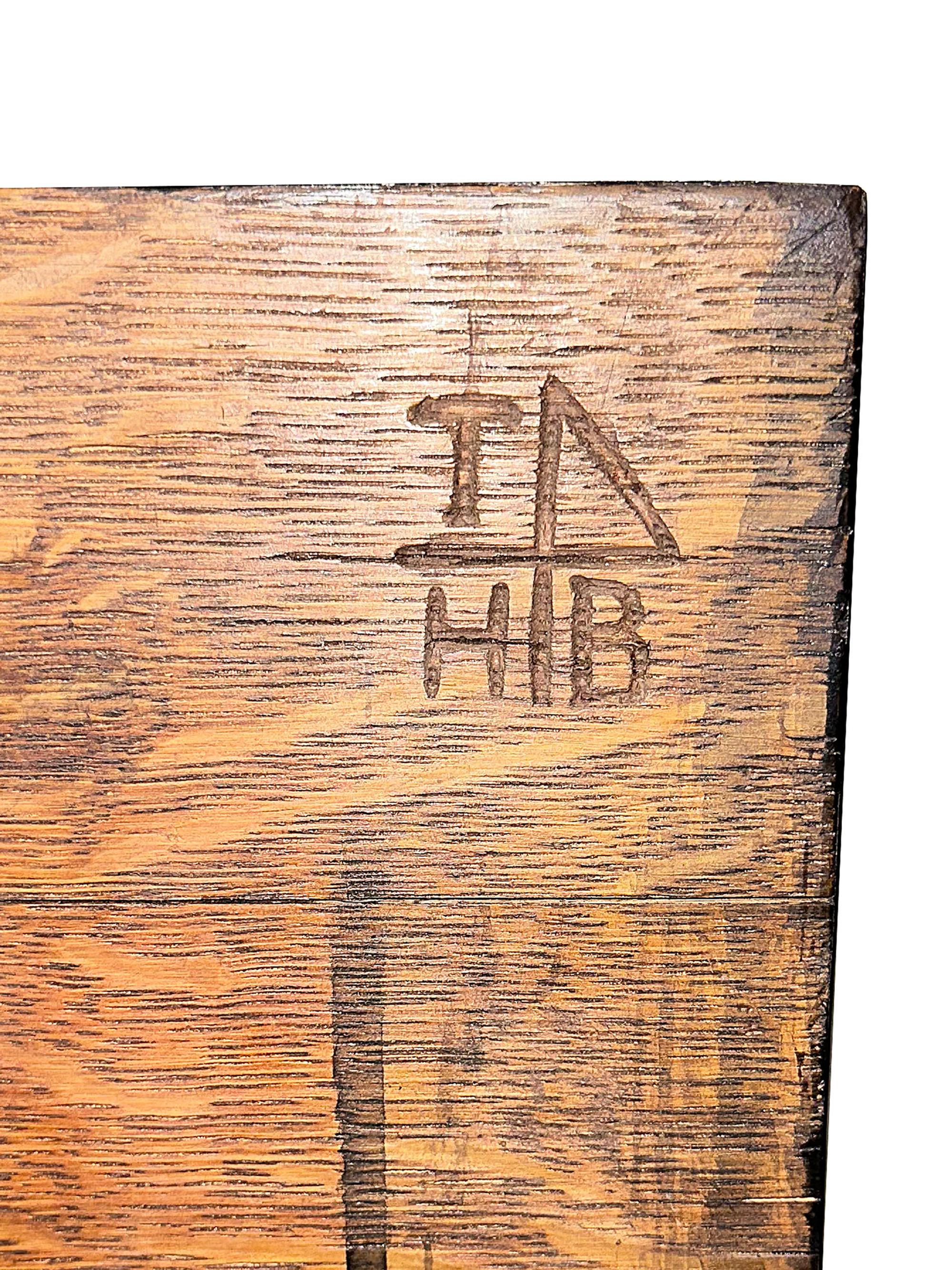 An Arts and Crafts Carved Oak Wine Cellarette