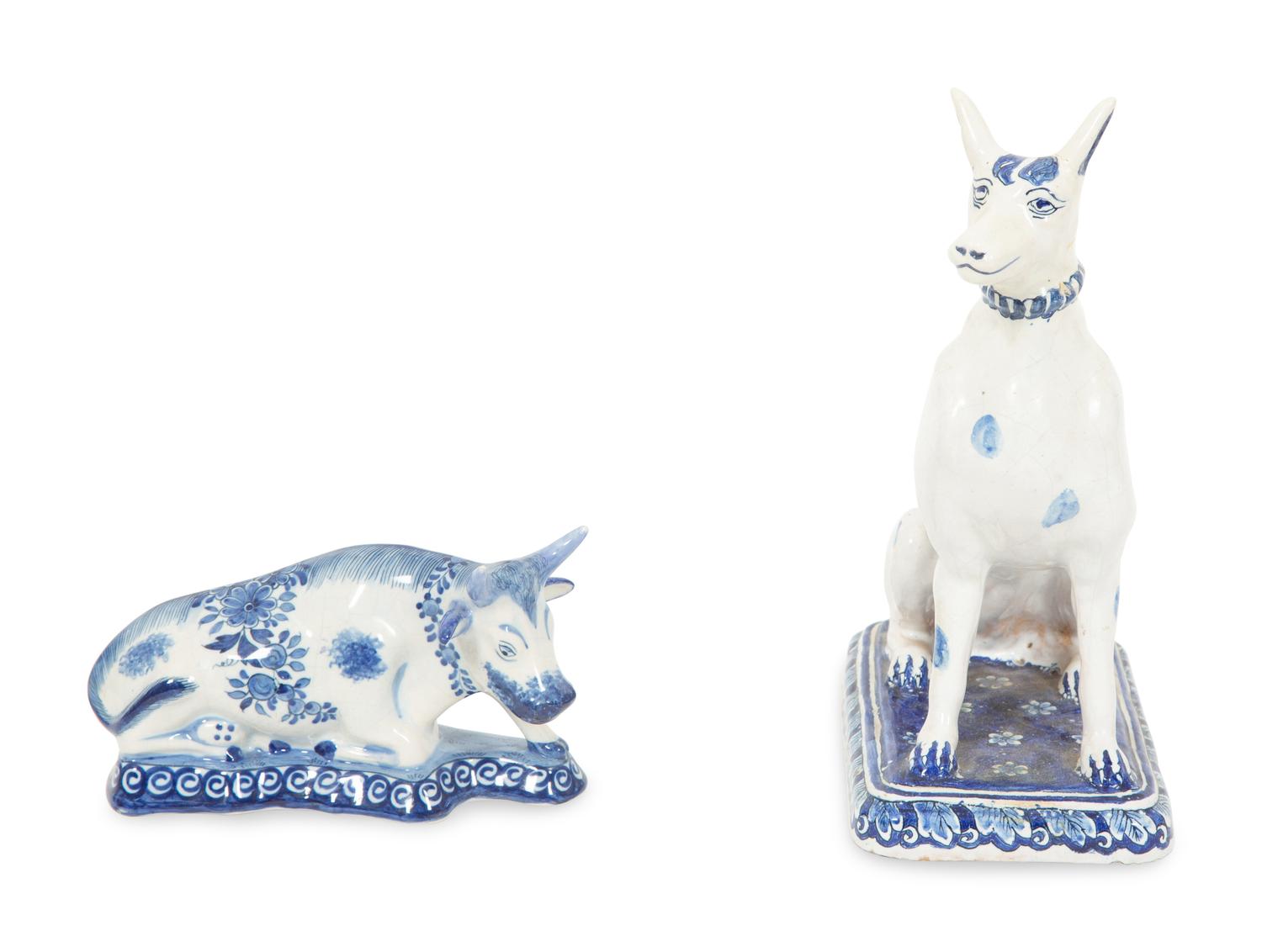 A Delft Blue and White Seated Dog and a Recumbent Cow