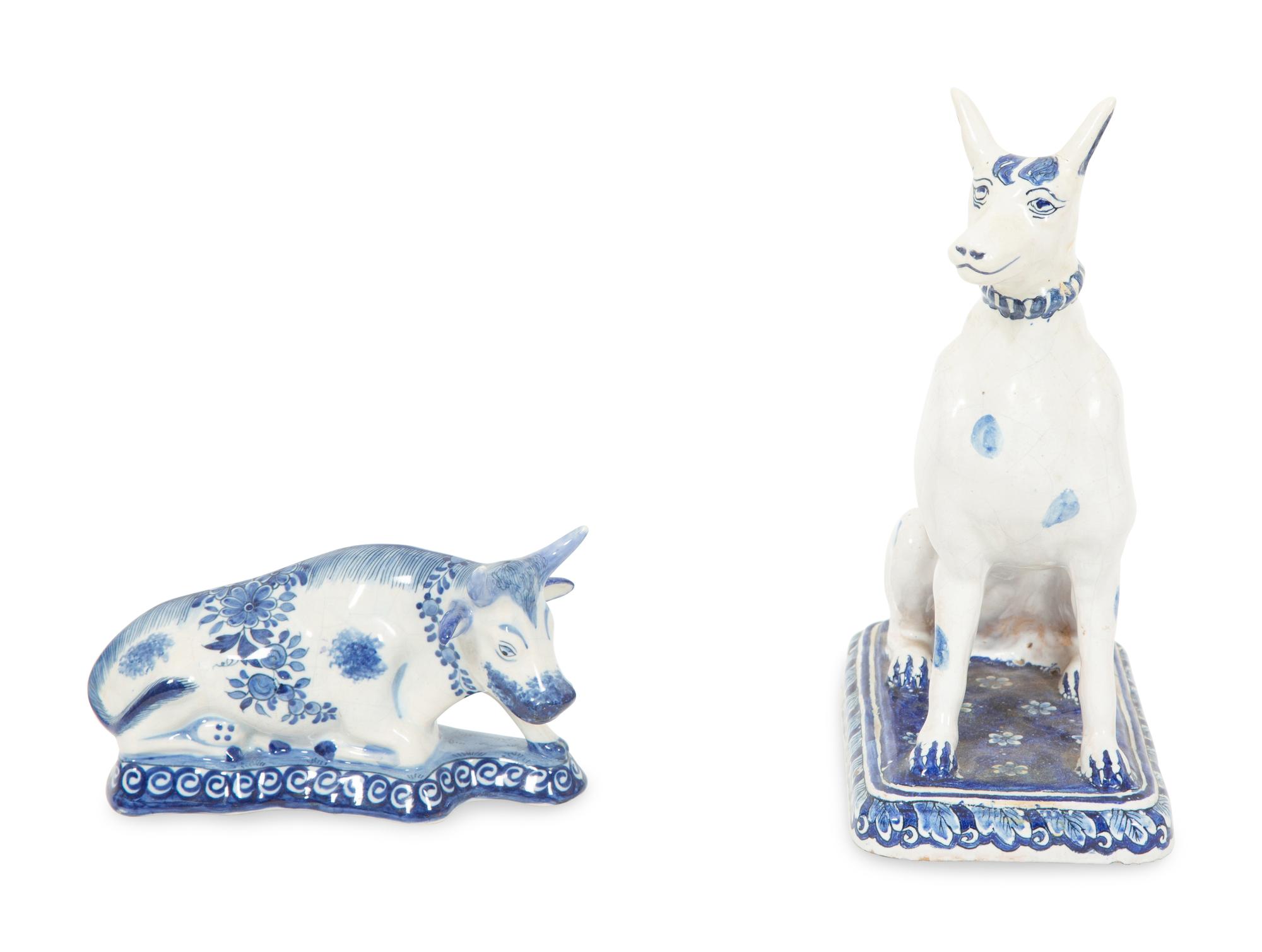 A Delft Blue and White Seated Dog and a Recumbent Cow