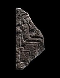 An Egyptian Limestone Stele Fragment with a Seated Pharaoh