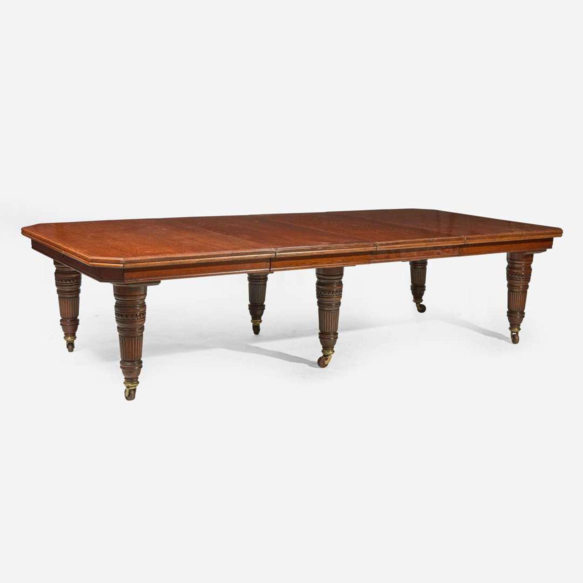 An English Aesthetic Movement carved oak dining table and set of twelve dining chairs Lamb of Manchester, Manchester, England, circa 1875