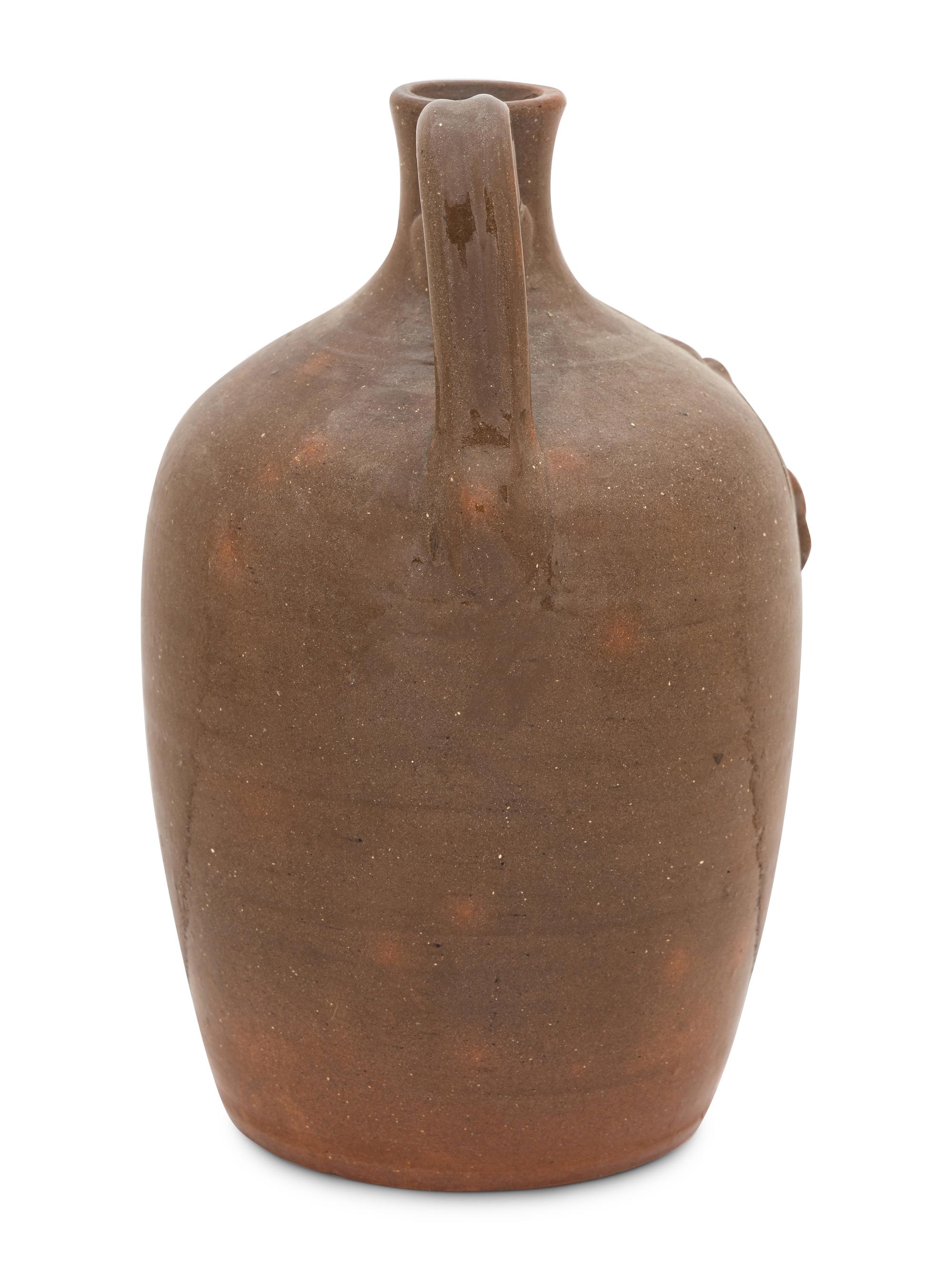 A Cole Pottery Glazed Stoneware Face Jug