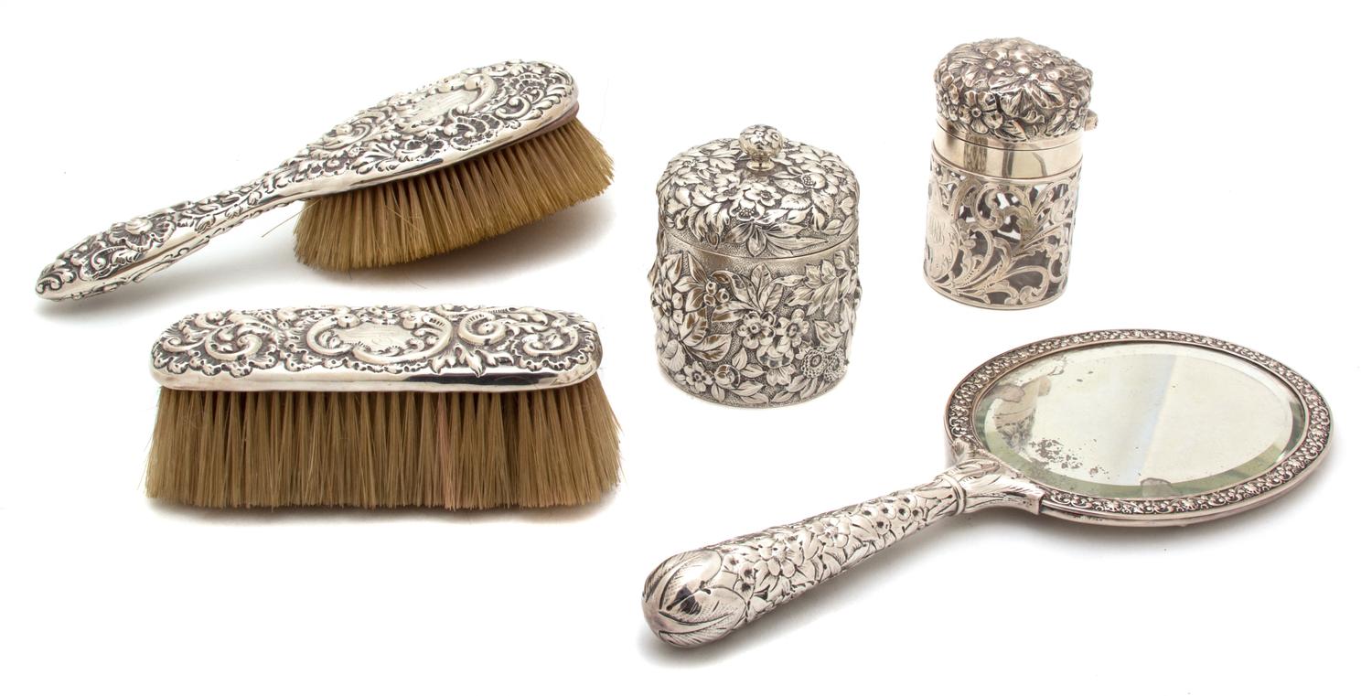 An American Silver Repousse Vanity Set, J.E. Caldwell, Philadelphia, PA, 19th Century, comprising two jars with covers, a brush, a hand