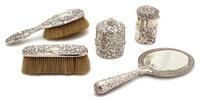 An American Silver Repousse Vanity Set, J.E. Caldwell, Philadelphia, PA, 19th Century, comprising two jars with covers, a brush, a hand