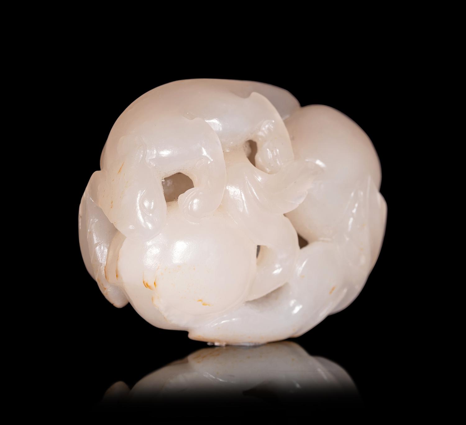 A White Jade Carving of Squirrel and Peaches