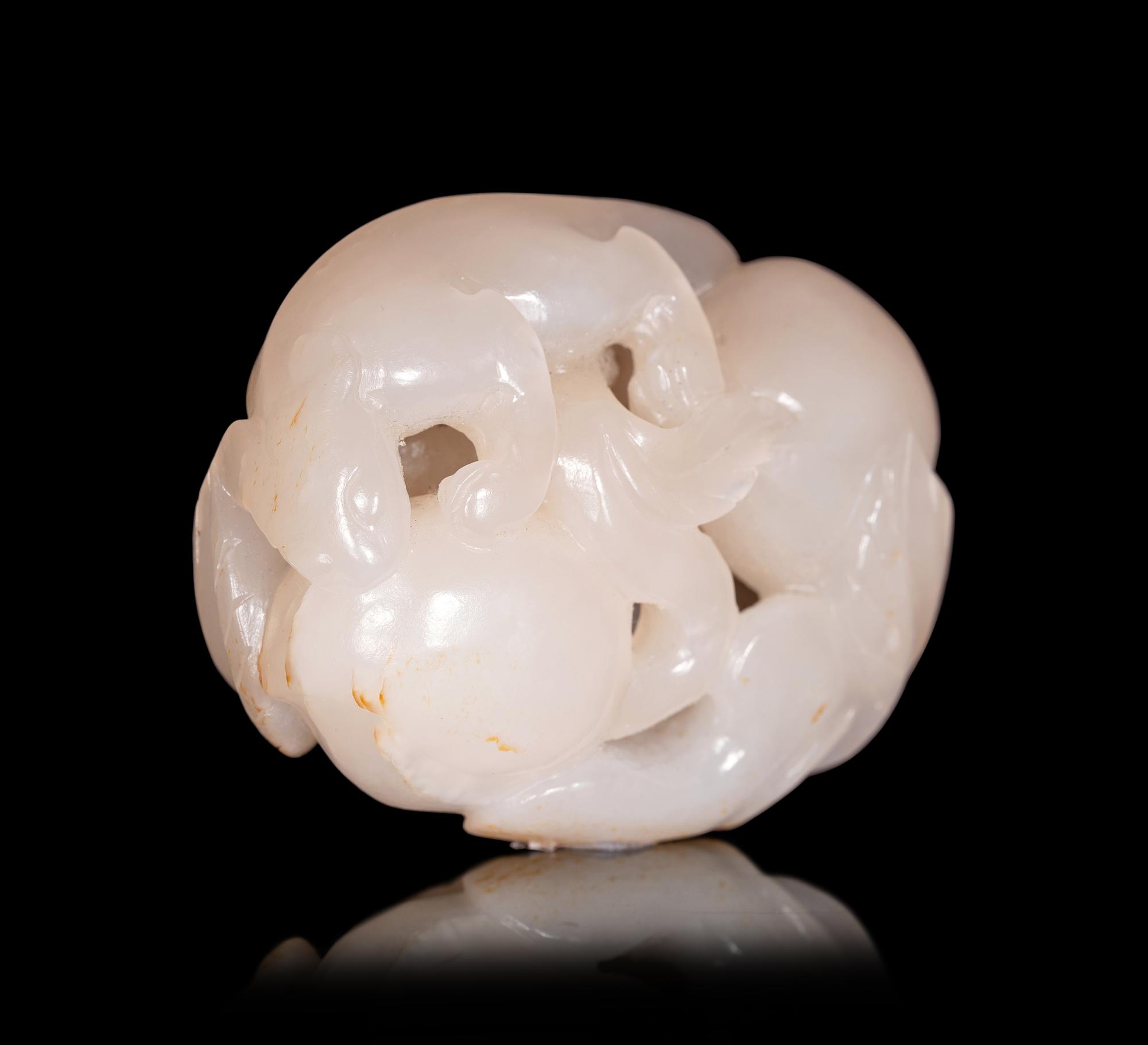 A White Jade Carving of Squirrel and Peaches