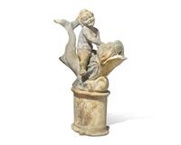 A lead or zinc fountain head in the form of a putto riding a dolphin, 19th / 20th century